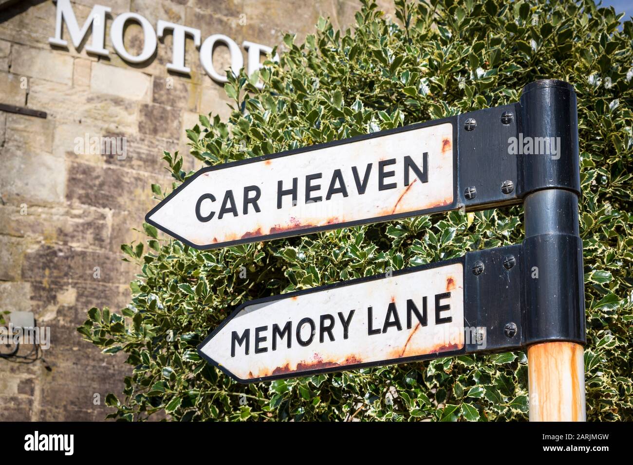 Tourism signs in Bourton-on-the-Water Gloucestershire England UK marking the location of the famous motor museum and toy collection for the benefit of Stock Photo