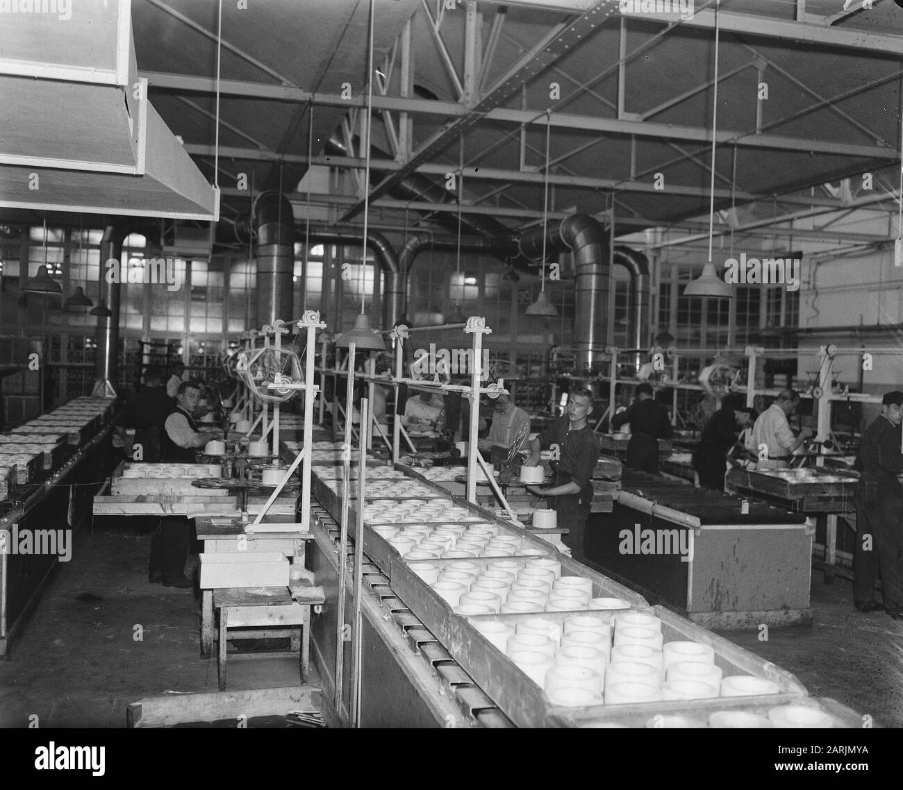 In the war-torn city of Arnhem, hard work is being done to build the art silk industry. This product so important for Dutch textile supply is manufactured here at the A.K.U. (Arnhemse Kunstzijde Union) Date: 28 May 1947 Location: Arnhem Keywords: industry, textile industry Stock Photo