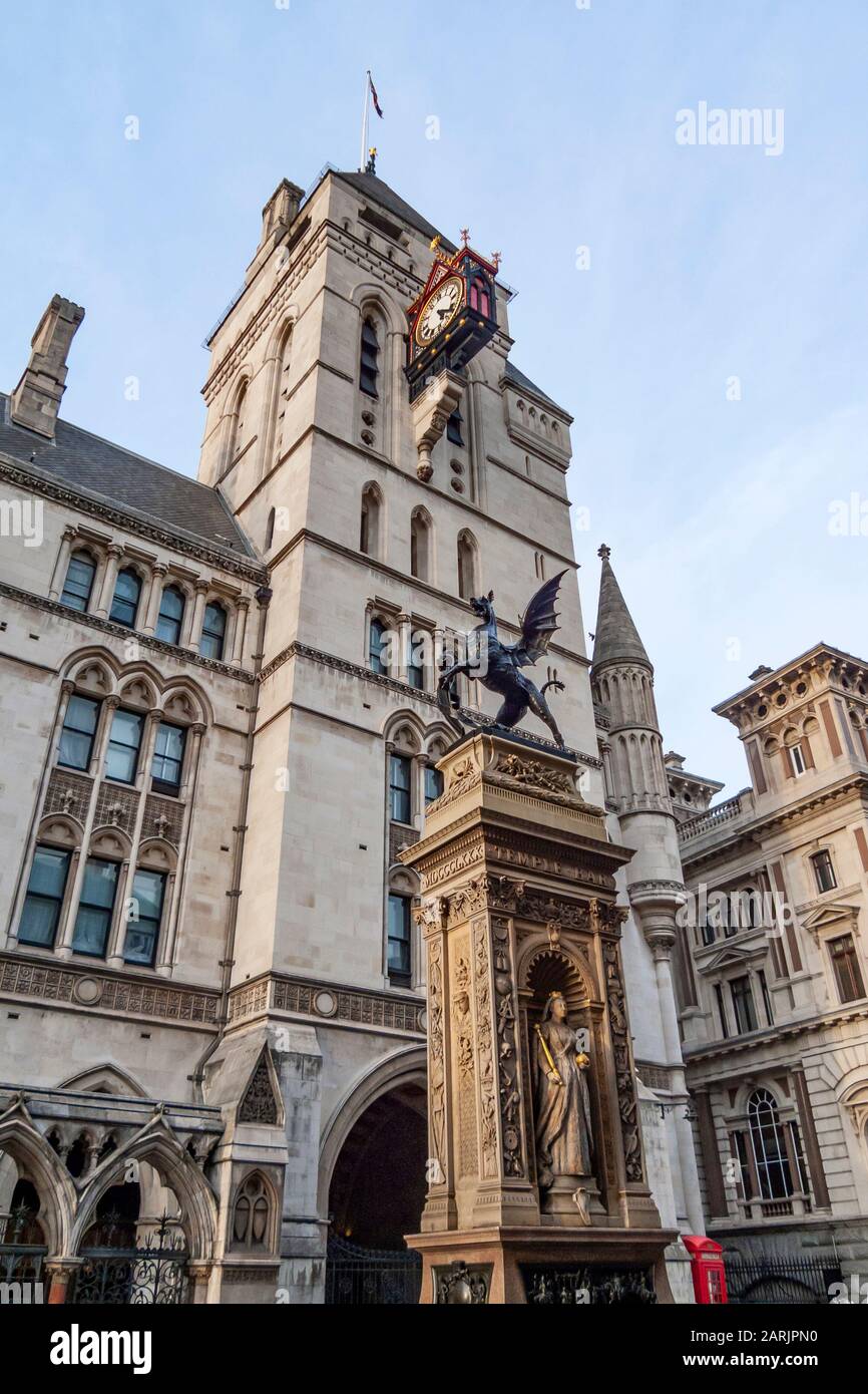 C.B. Birch's City of London Dragon statue is seen in front of the Royal Courts of Justice clock tower on Fleet Street, City of London, England, UK. Stock Photo