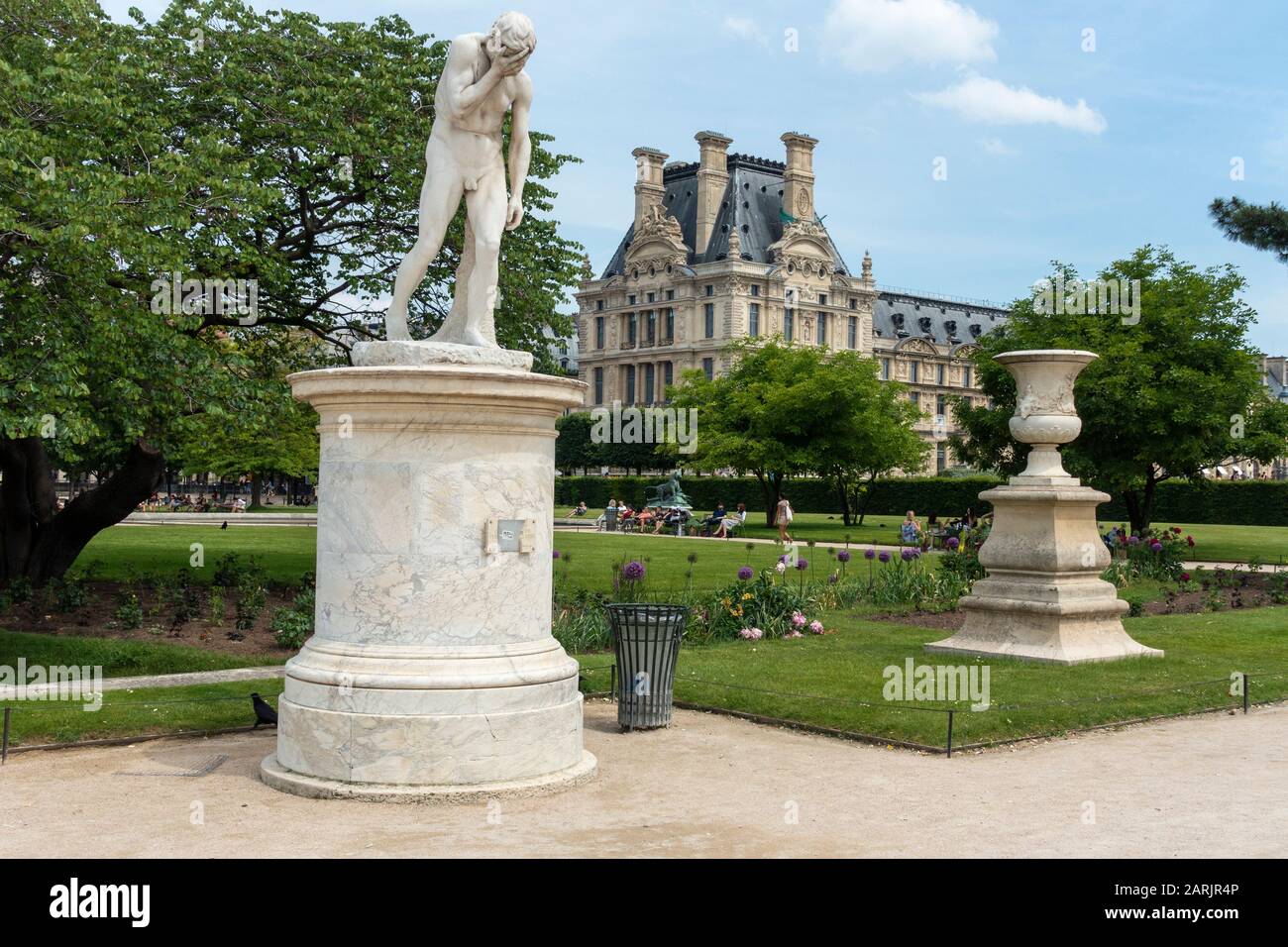 Cain statue in Tuileries Garden (Jardin des Tuileries) with Richelieu Wing of the Louvre Museum in background, Tuileries Quarter, Paris, France Stock Photo