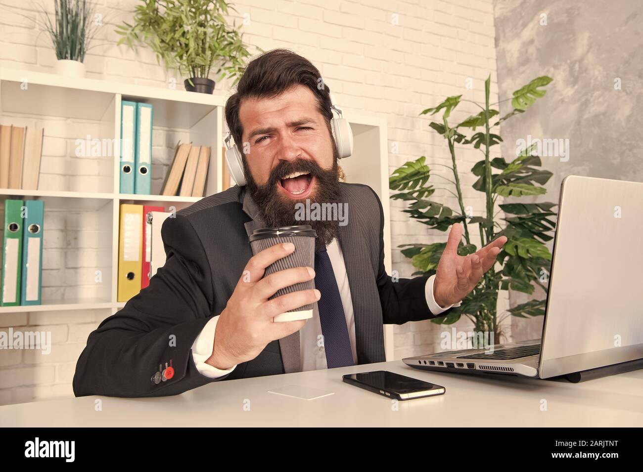 Singer or manager. Office manager sing karaoke using coffee cup