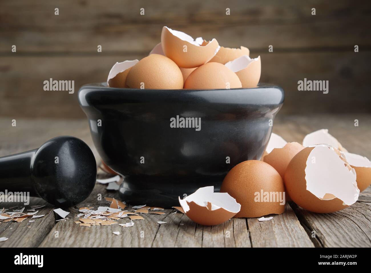 Mortar of eggshell. Shell of eggs on wooden kitchen table. Stock Photo