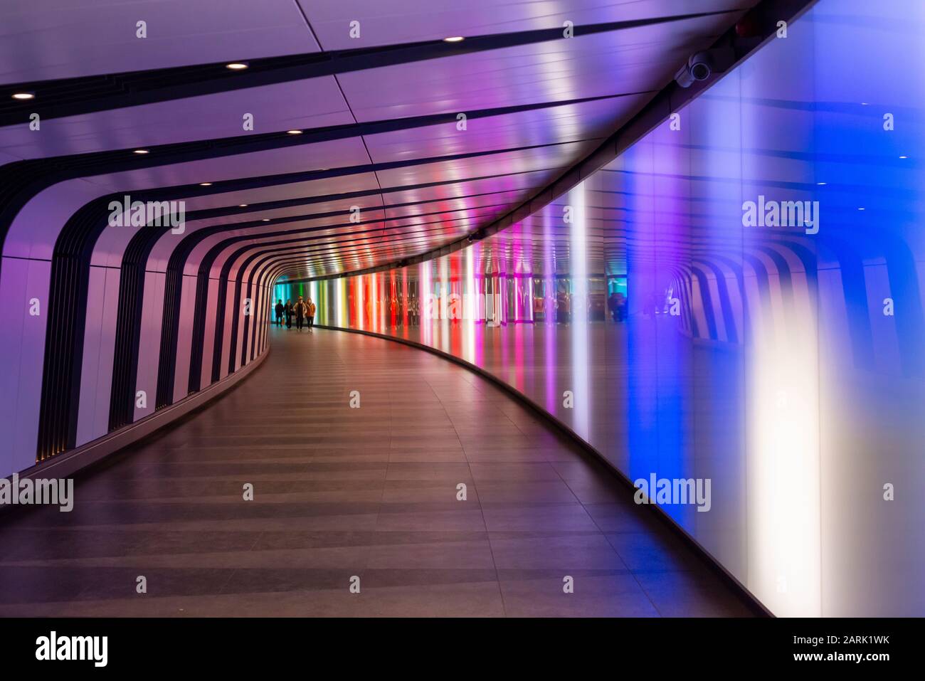 Illuminated, colourful, pedestrians, commuters, underpass, light tunnel, subway, One Pancras Square, King’s Cross St Pancras, Undergound Station, London, United Kingdom, UK, 2020, tunnel, commuting, commute, walkway, lightwall, corridor, colorful, urban, public, passageway, Stock Photo