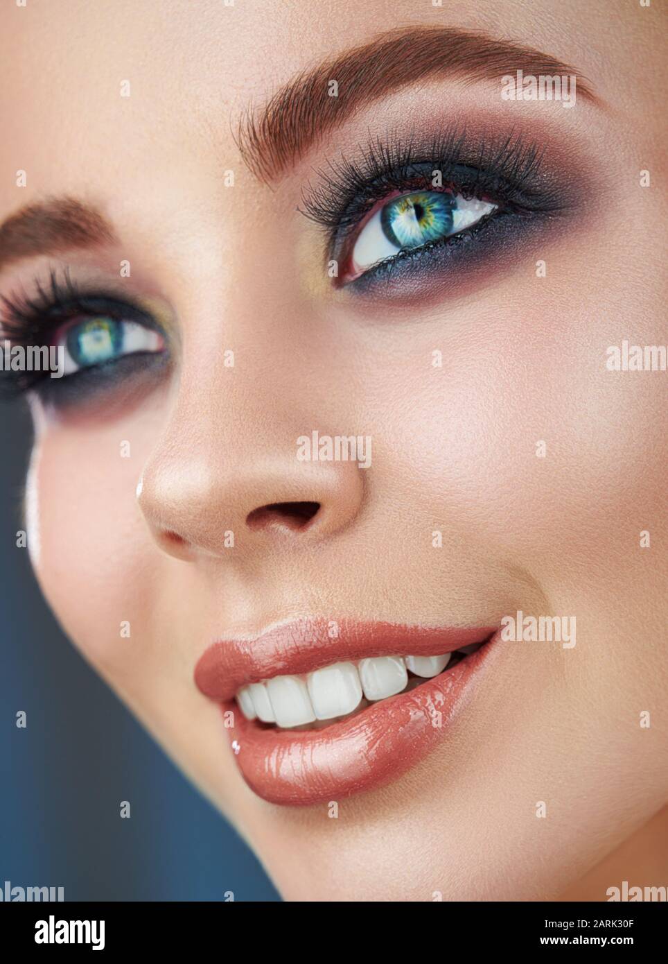 Close-up of a beautiful young smiling woman with trendy natural makeup Stock Photo