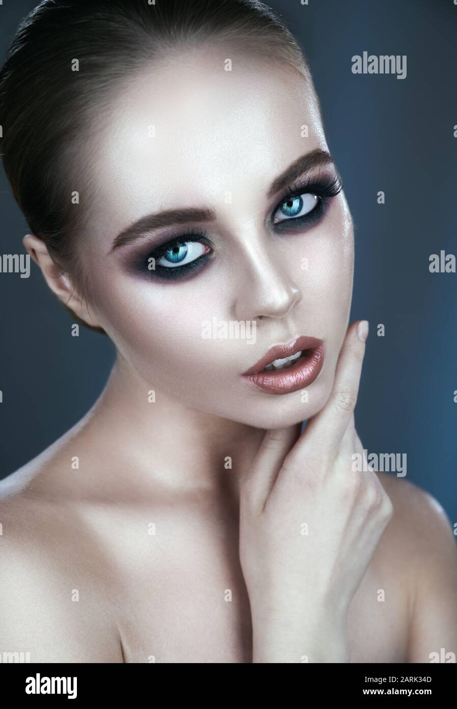 Close-up portrait of a beautiful young woman with smokey eyes and natural make-up Stock Photo