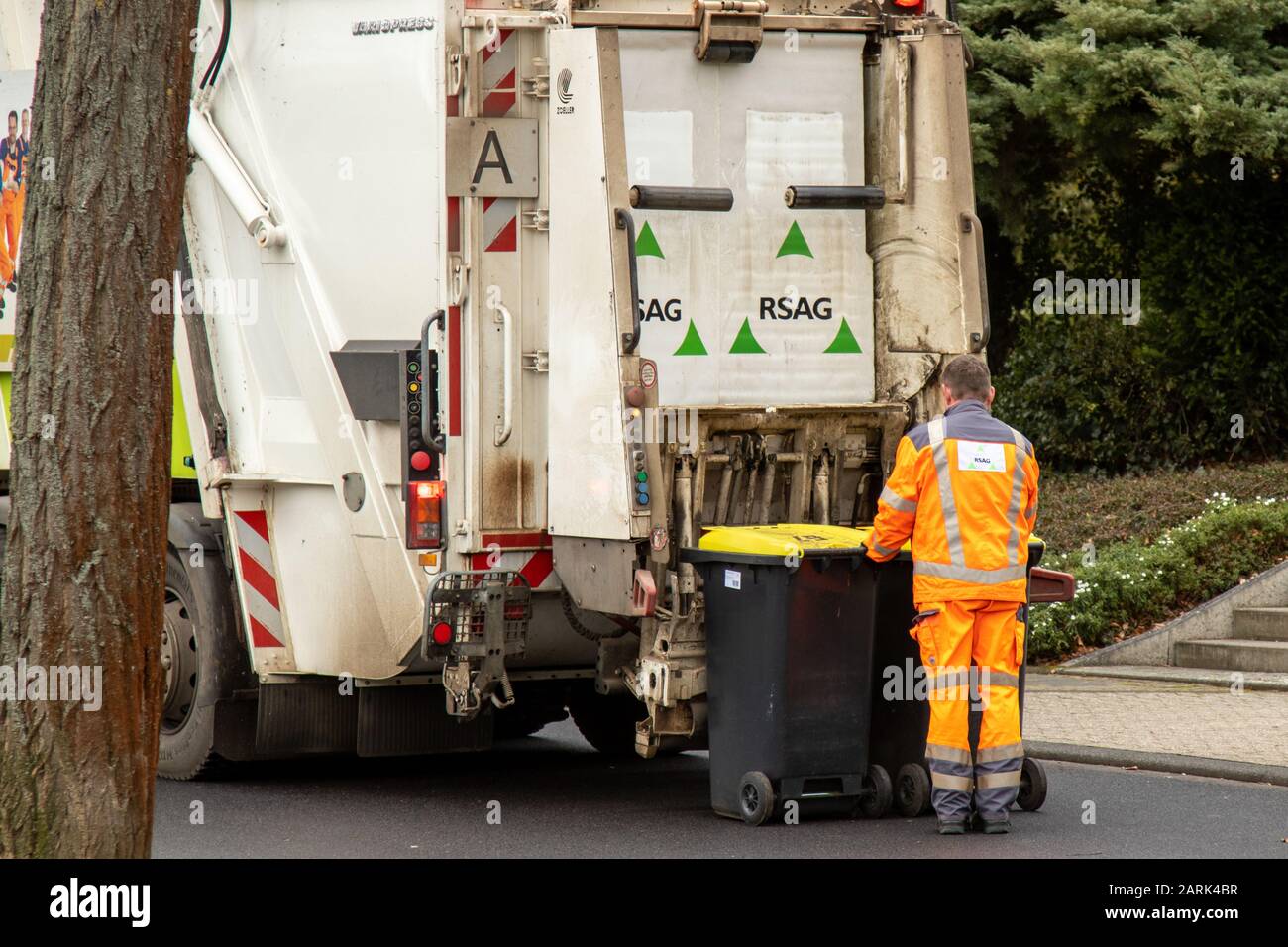 garbage truck and ladder emptying garbage cans, Meckenheim NRW Germany - 27 01 2020 Stock Photo