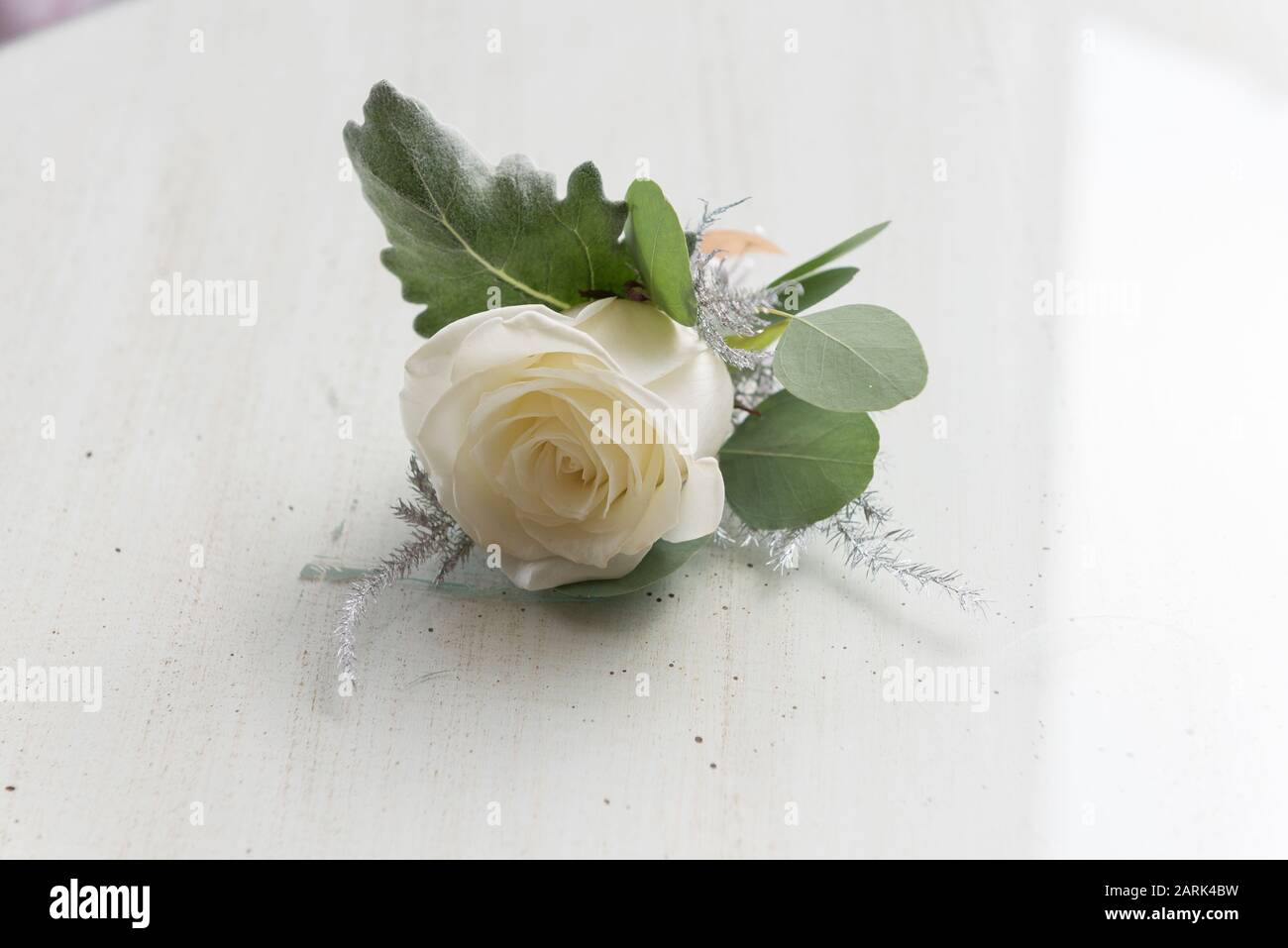 White Button hole flowers isolated on table Stock Photo