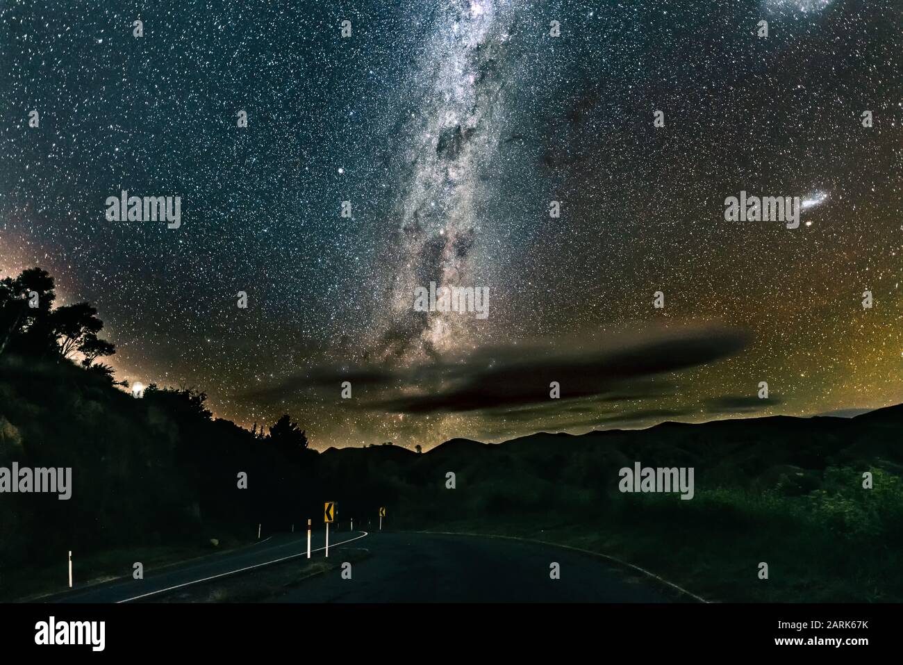 Starry night sky over road in New Zealand Stock Photo