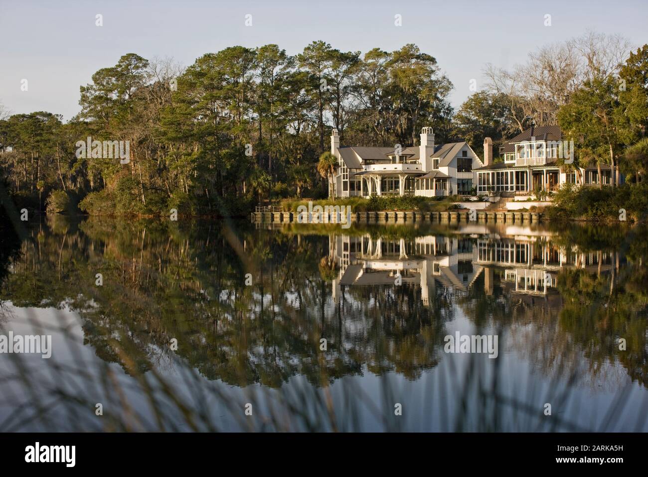 House reflected in placid lake Stock Photo