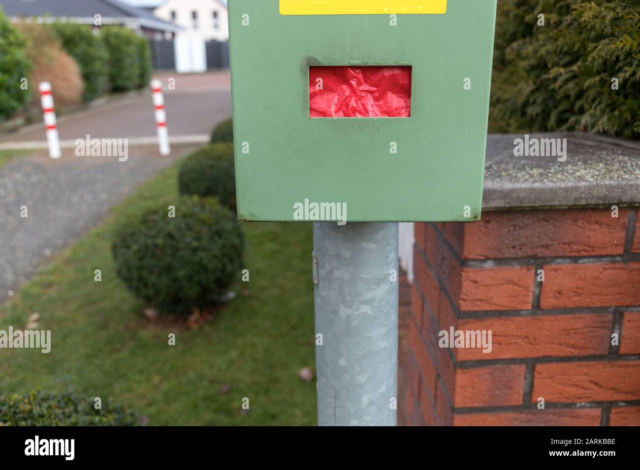 a green box with red paper bags to put dog excrements in it Stock Photo