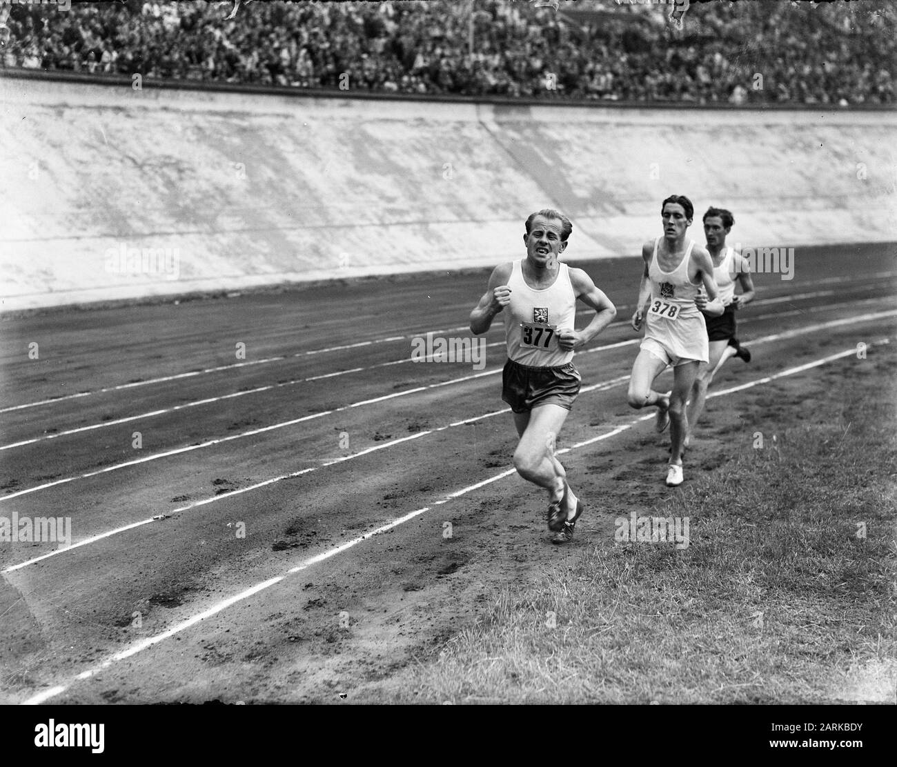 International Athletics Competition at the Olympic Stadium. Emil Zatopek Annotation: With behind him Erik Ahlden and Willem Slijkhuis (dark pants) Date: 13 August 1948 Keywords: athletics, sports Person name: Zatopek, Emil Stock Photo