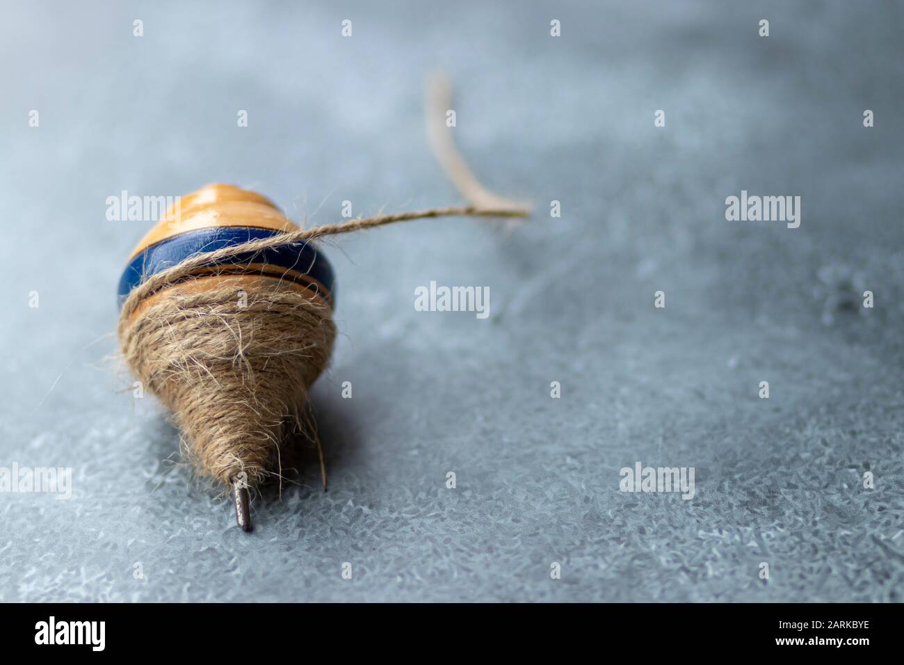 Classic wooden spinning top toy with string Stock Photo Alamy
