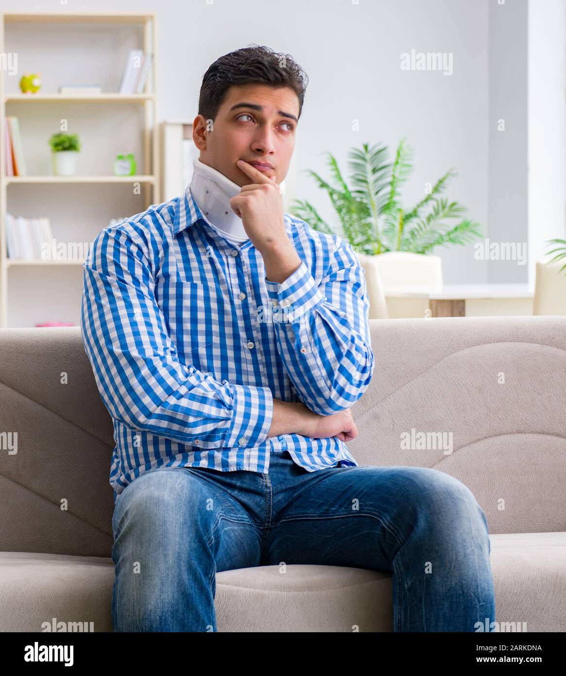 Young man suffering a neck spine head trauma wearing a cervical collar
