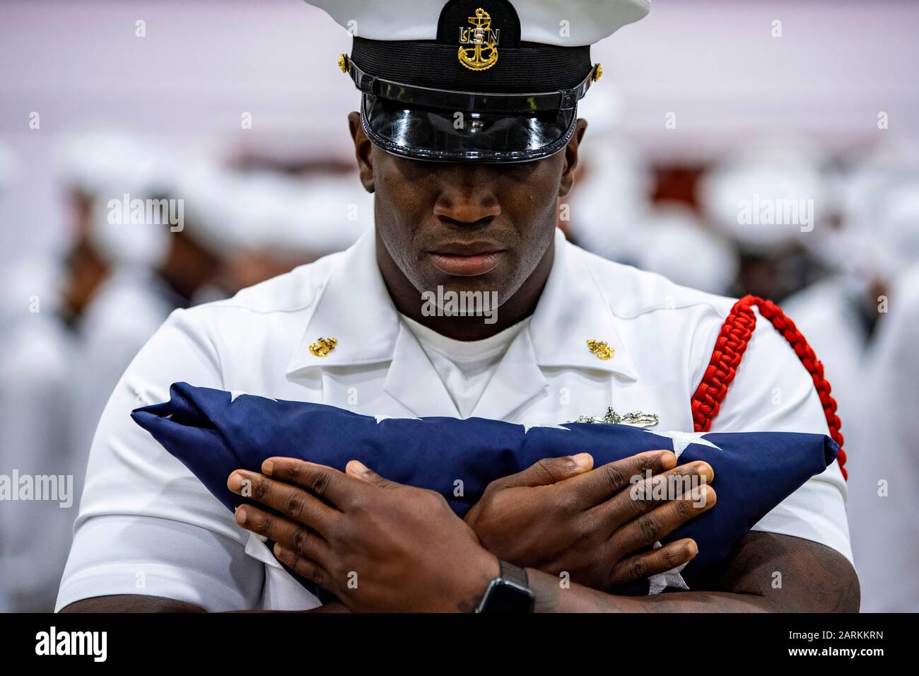 190906-N-PL946-1213 GREAT LAKES, Ill. (Sep. 6, 2019) Chief Fire Controlman (Aegis) Daniel Rainmaker, a recruit division commander, holds the American flag before a flag presentation ceremony in remembrance of 9/11 during a pass-in-review graduation ceremony at Recruit Training Command (RTC). RTC presented the flag to Kenneth Corrigan, a Navy veteran and first responder to the 9/11 attacks on the World Trade Center. More than 35,000 recruits train annually at the Navy's only boot camp. (U.S. Navy photo by Mass Communication Specialist 1st Class Spencer Fling) Stock Photo