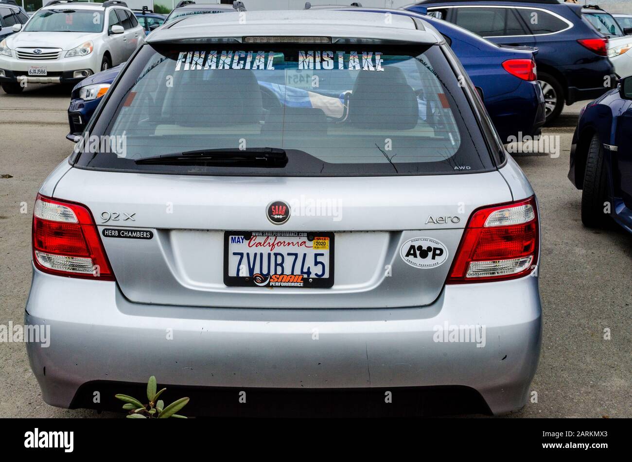 What must be a trade in on a car dealer lot with a sign showing regret for buying the wrong car a Saab 92 Stock Photo