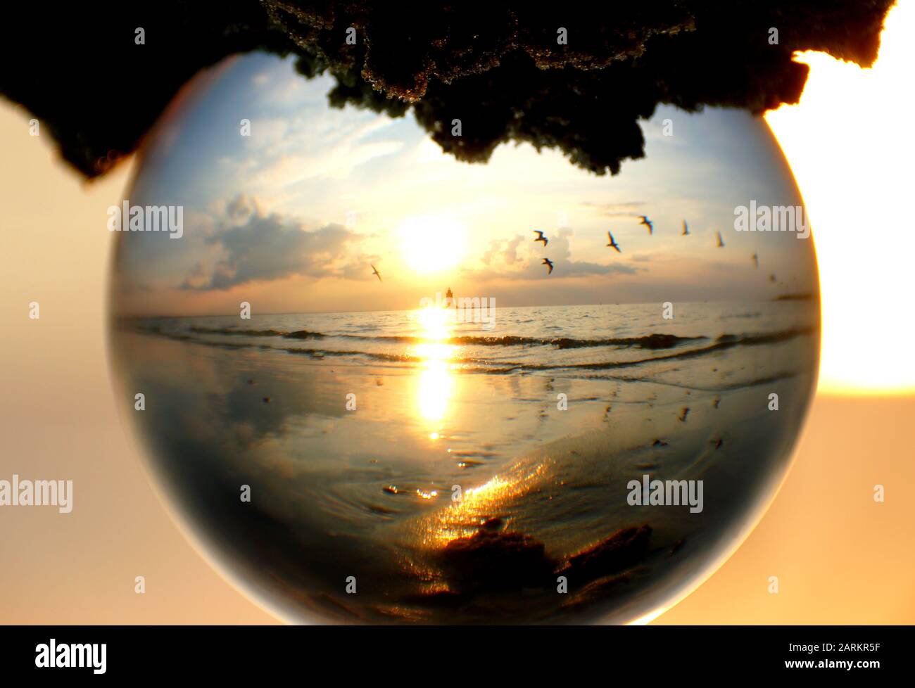 Beautiful sunset captured through a glass lens ball at Cape Henlopen ...