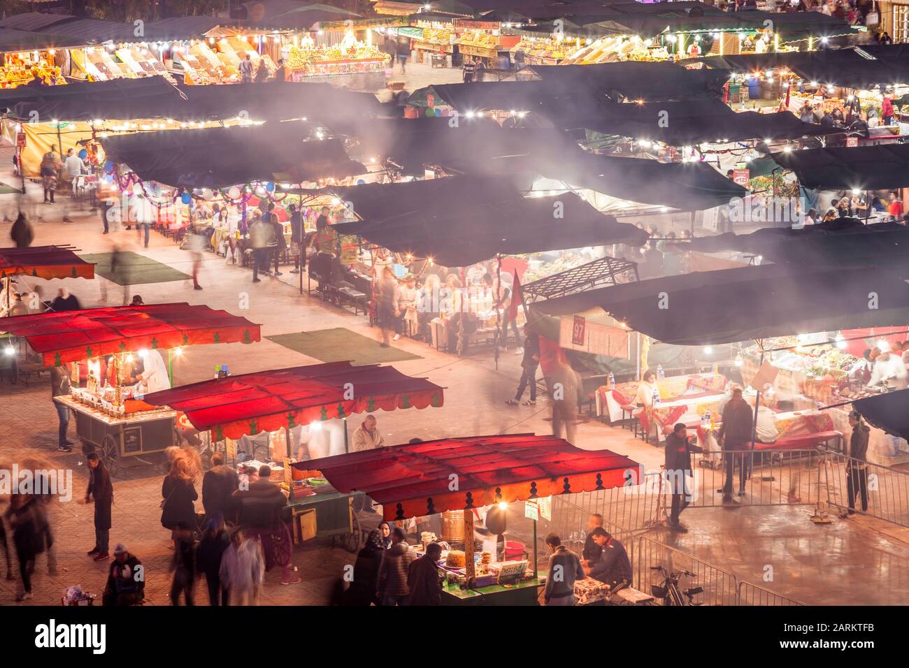 Covered Souq stalls or food stalls at a busy Jemaa el-Fnaa at dusk in Marrakesh, Marrakesh-Safi Morocco. Stock Photo