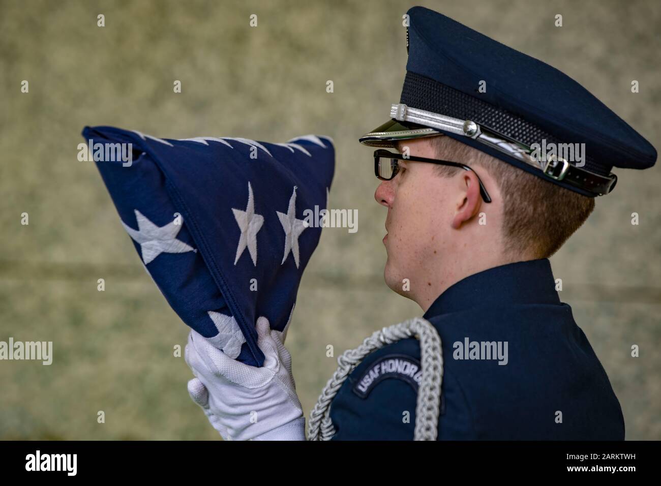 Senior Airman Donald Lambert, a member of the 130th Airlift Wing Honor Guard, inspects a flag before handing it off at the funeral of Brig. Gen. (ret.) James Kemp McLaughlin on Dec. 23, 2019, in Charleston, W.Va. McLaughlin was a World War II B-17 Flying Fortress pilot who flew 39 total combat missions and was the founder and first commander of the West Virginia Air National Guard. McLaughlin died Dec. 15, 2019 at the age of 101. (U.S. Air National Guard Photo by Senior Airman Caleb Vance) Stock Photo