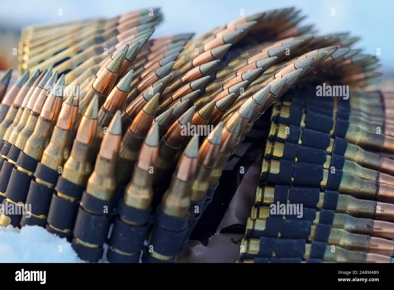 Belts of 7.62mm ammunition. Ammunition- - informally ammo - is the material fired, scattered, dropped or detonated from any weapon. Ammunition is both expendable weapons (e.g., bombs, missiles, grenades, land mines) and the component parts of other weapons that create the effect on a target (e.g., bullets and warheads).[1] Nearly all mechanical weapons require some form of ammunition to operate.  The term ammunition can be traced back to the mid-17th century. The word comes from the French la munition, for the material used for war. Stock Photo