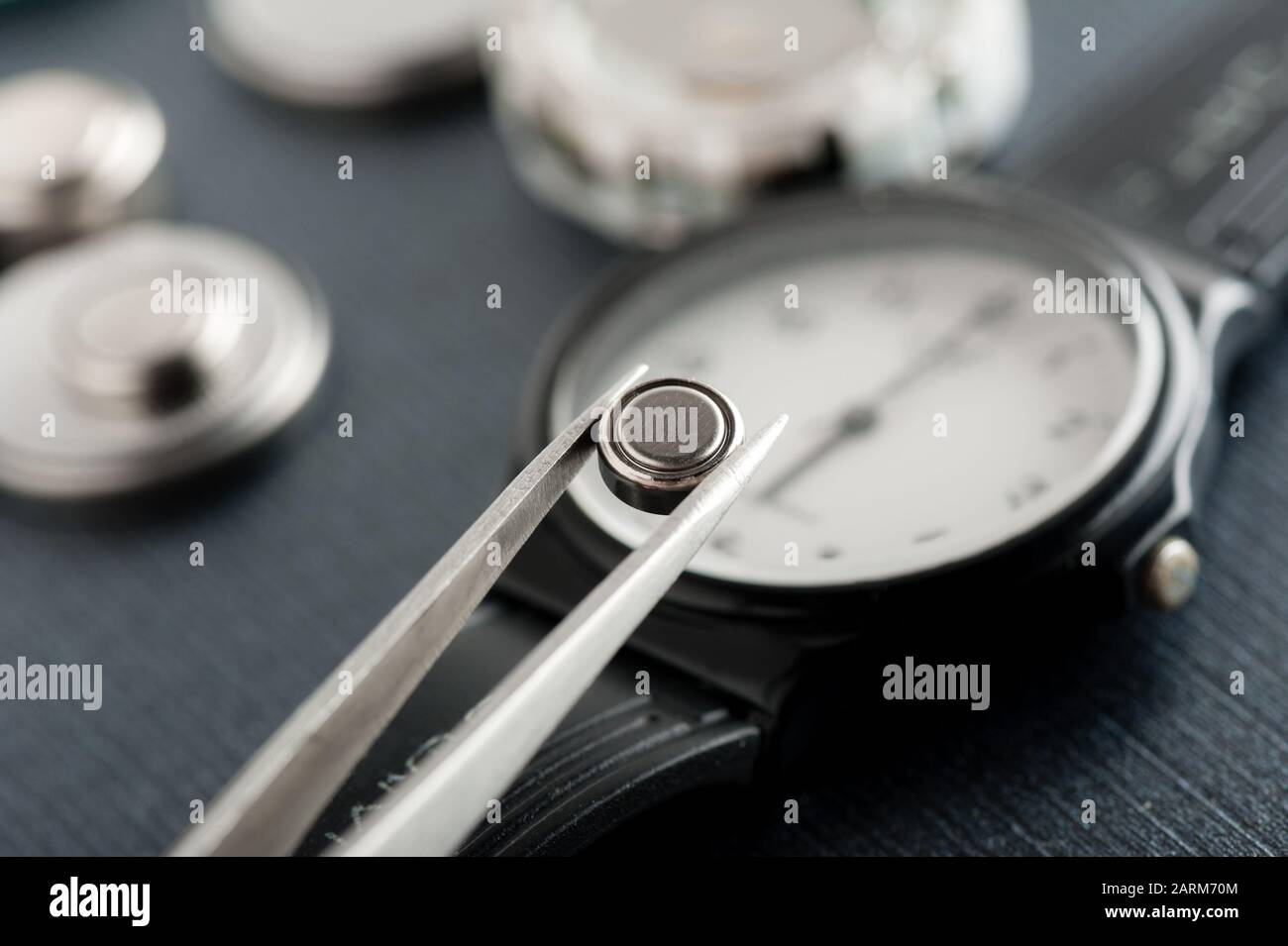 closeup button cell battery or watch battery or coin cell, used to power small electronics devices such as wrist watches or computer motherboard. Stock Photo