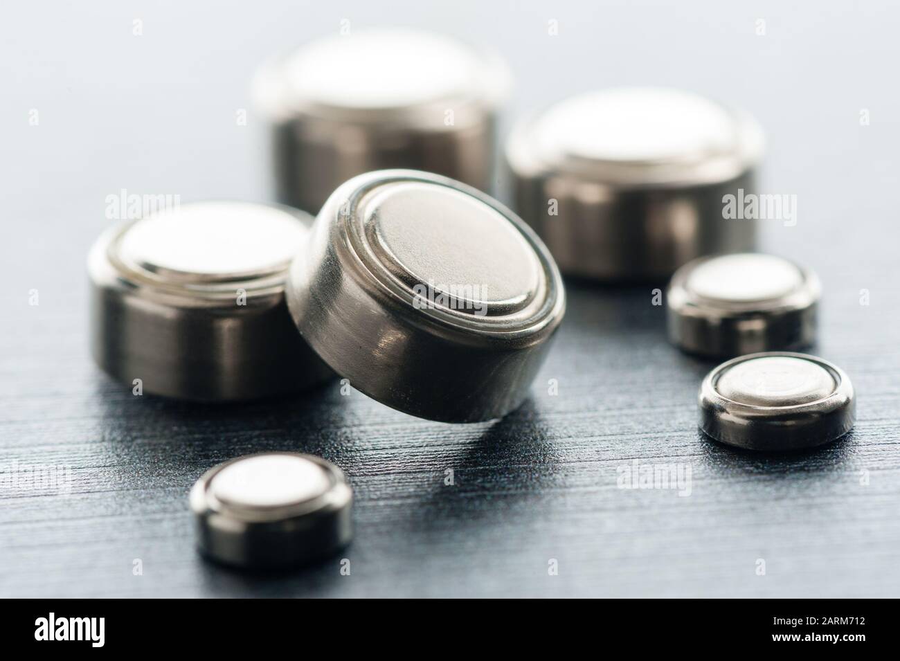 closeup button cell battery or watch battery or coin cell, used to power small electronics devices such as wrist watches or computer motherboard. Stock Photo