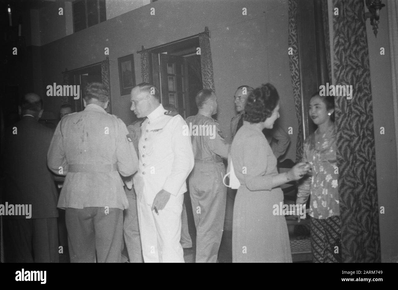 The army commander, Lieutenant General S.H. Spoor, offers British officers a cocktail party to leave  Vice Admiral A.S. Pinke in white uniform Date: November 17 1946 Location: Indonesia, Dutch East Indies Stock Photo