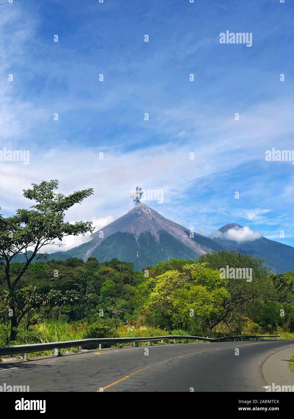 Guatemala's Fuego and Acatenango Volcanoes seen from a highway Stock Photo