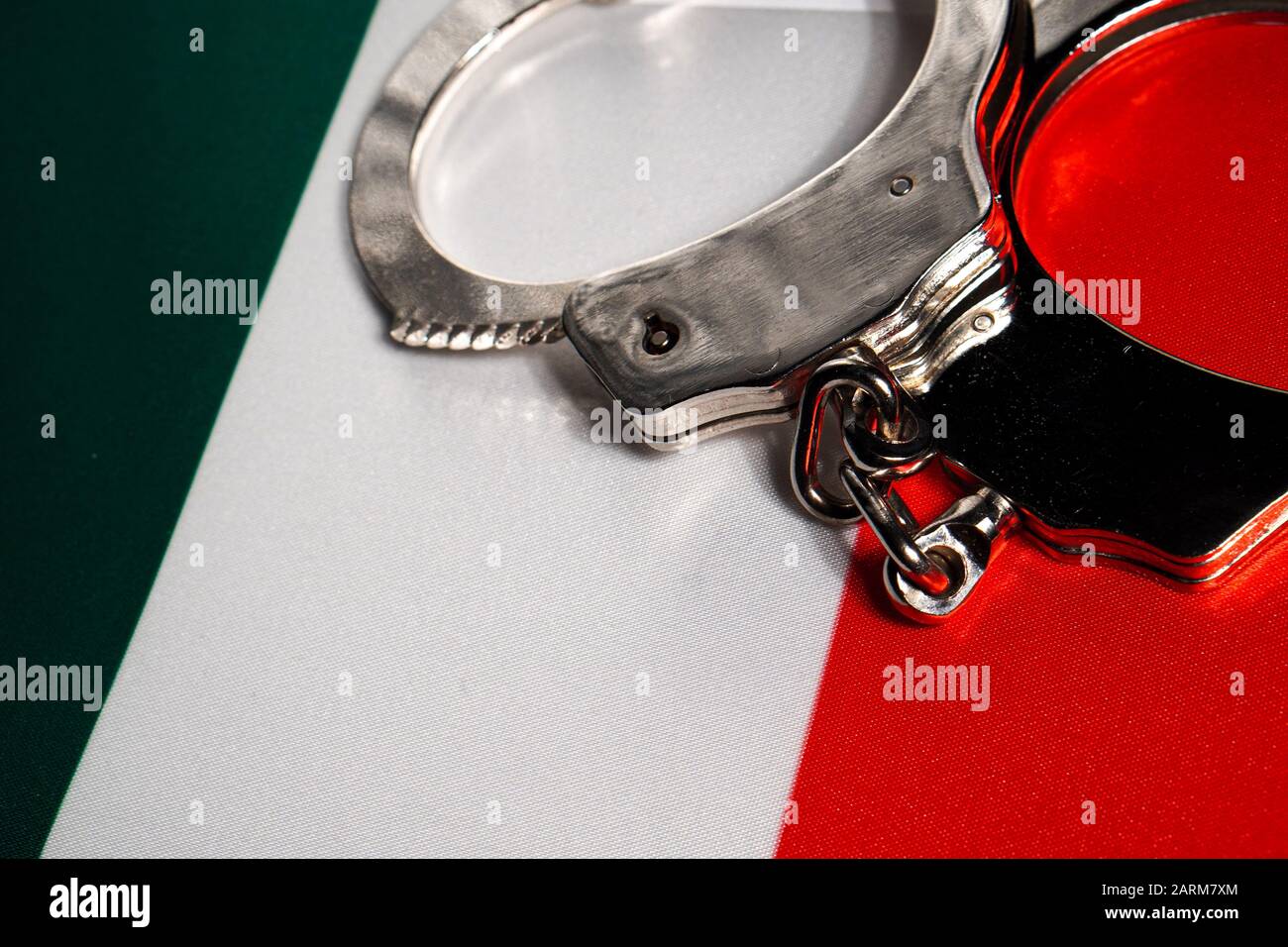 Handcuff on the flag of Italy. Closeup, copy space Stock Photo Alamy