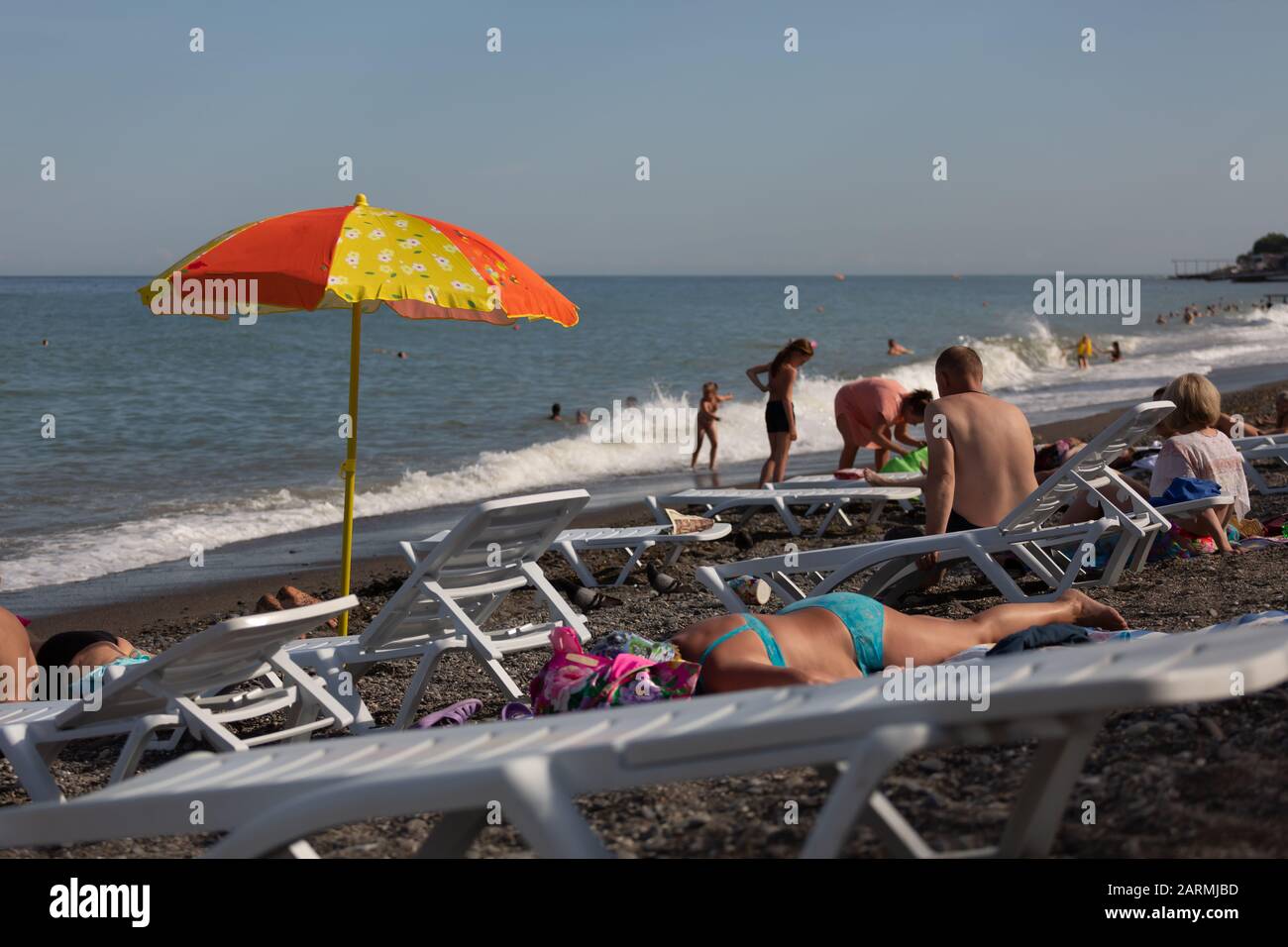 beach parasol, woman laying, tourism travel, dry grass, alushta crimea, senior couple, seaside resort Stock Photo