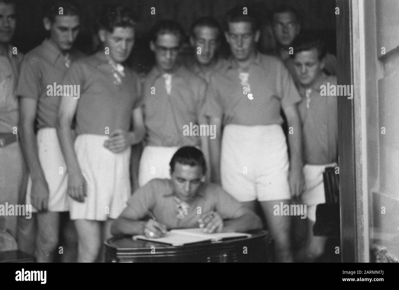 Two years under the arms. A certificate presented to General Dürst-Britt. Sports competitions to Bandoeng  [Celebration 2-Anniversary 7 December Division. Athletes sign a reception book] Date: 5 May 1948 Location: Bandung, Indonesia, Dutch East Indies Stock Photo