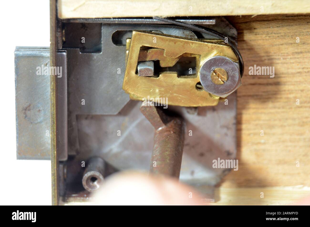 Closeup into a lock mechanism of a lever tumbler lock (front cover removed). The key does not fit, the front tumbler prevents an opening of the lockoc Stock Photo