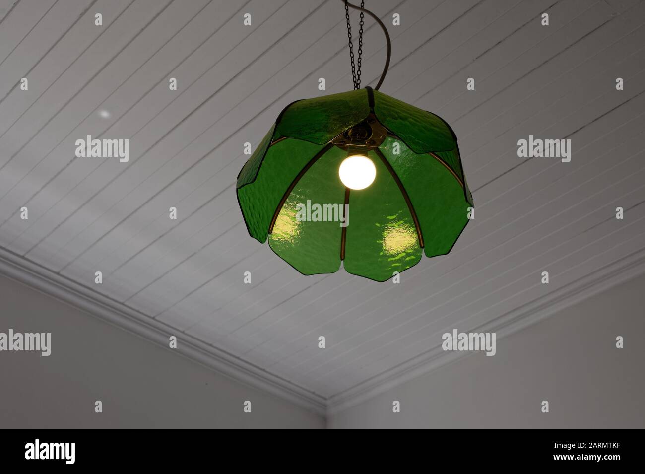 A Room Is Lit Up By An Electric Light That Has An Old Fashioned