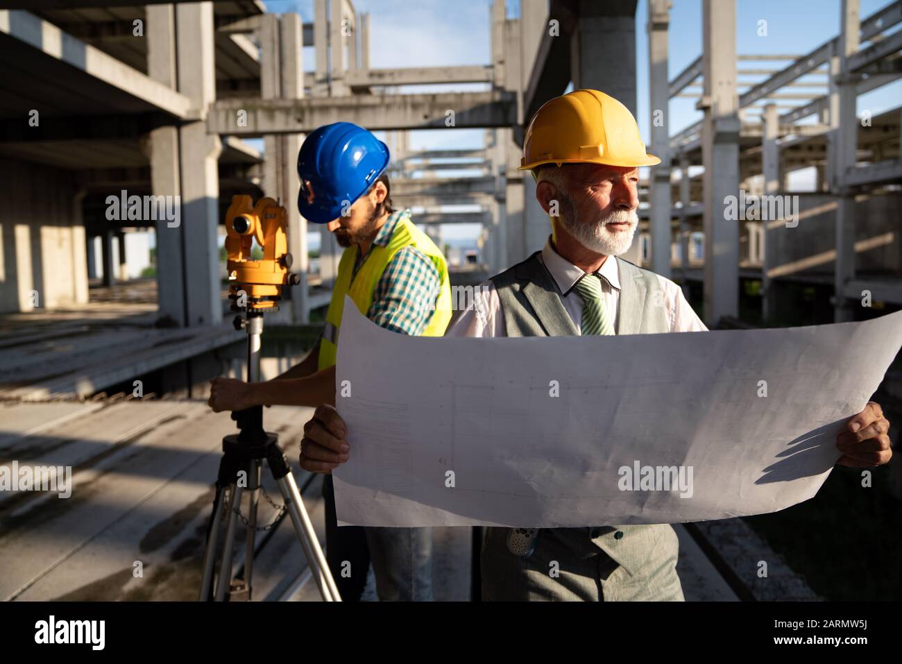 Team of construction engineers, architects working on building site ...