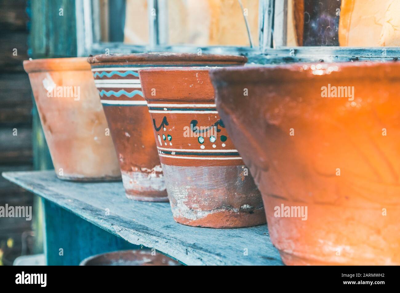 Vintage retro clay pots with ornamental pattern standing outdoors in countryside Stock Photo