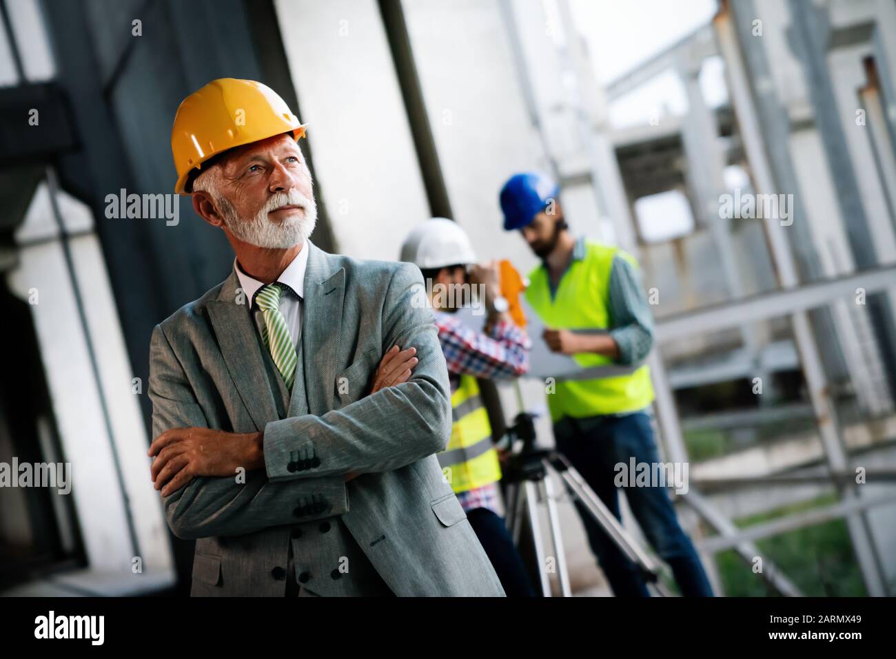 Team of construction engineers, architects working on building site ...