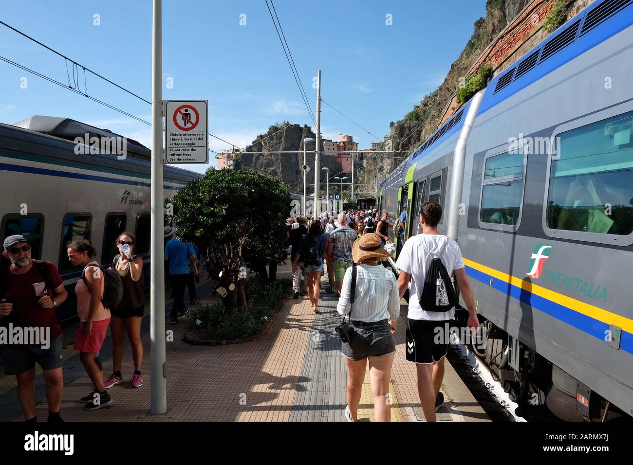 On the platform at Corniglia. Travelling the Cinque Terre five villages by train in summer on the Italian Riviera and UNESCO World Heritage Site Stock Photo