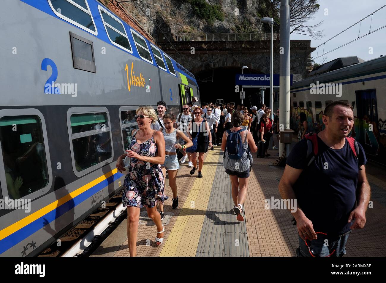 Running to catch the train - Travelling the Cinque Terre five villages by train in summer on the Italian Riviera and UNESCO World Heritage Site Stock Photo