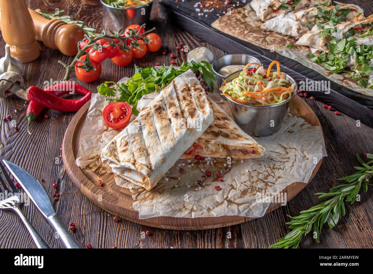 Grilled veggie shawarma and pita bread on wooden board, restaurant dish