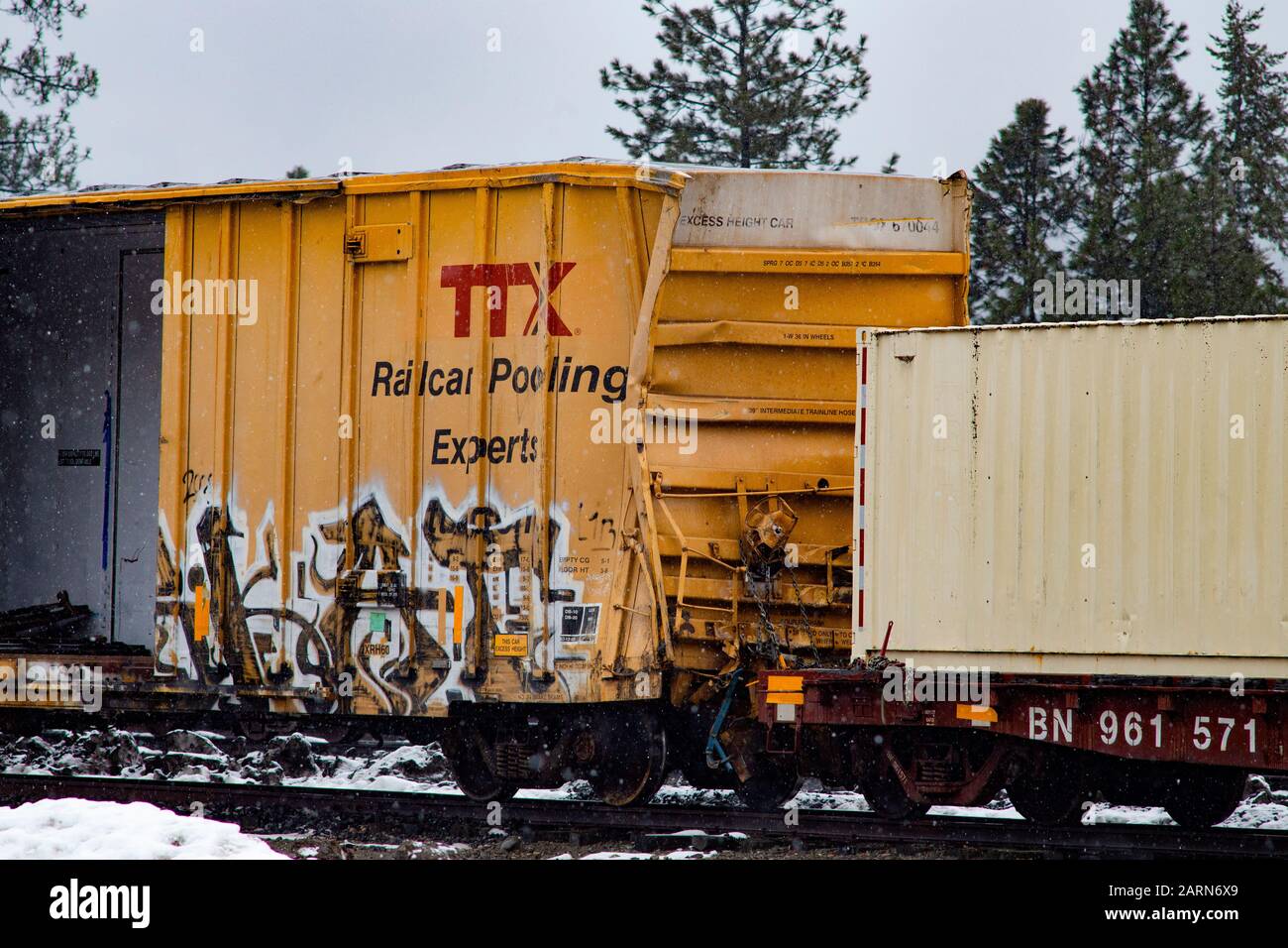 A crushed TTX Railroad box car In the BNSF train yard, in the town of Troy, Montana. Stock Photo