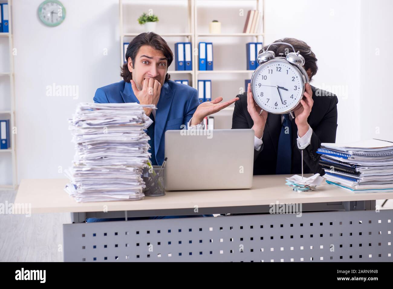 The two male colleagues unhappy with excessive work Stock Photo - Alamy