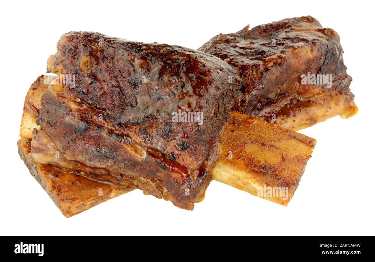 Two slow cooked beef short ribs isolated on a white background Stock Photo