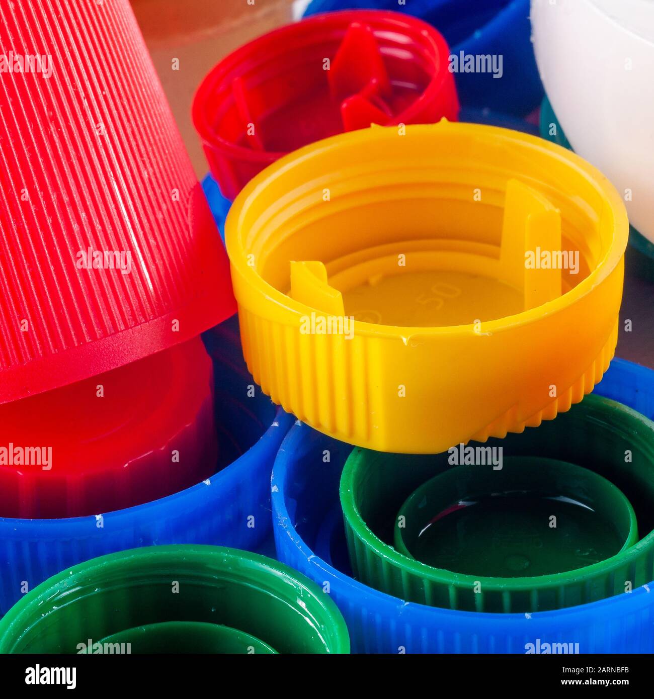 Colored plastic bottle caps. Plastic and the environment Stock Photo