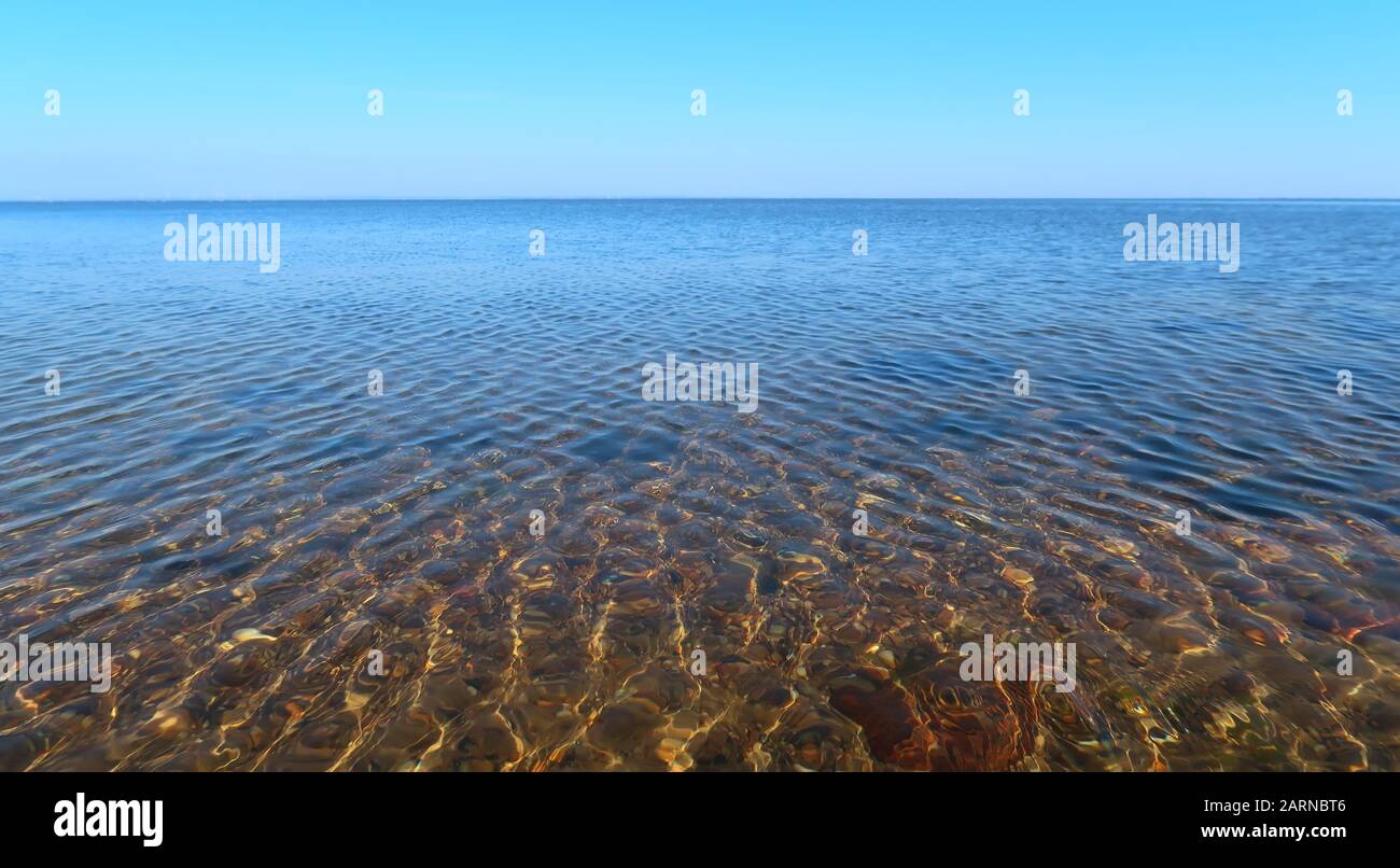 lake with calm water and a clear blue sky Stock Photo - Alamy