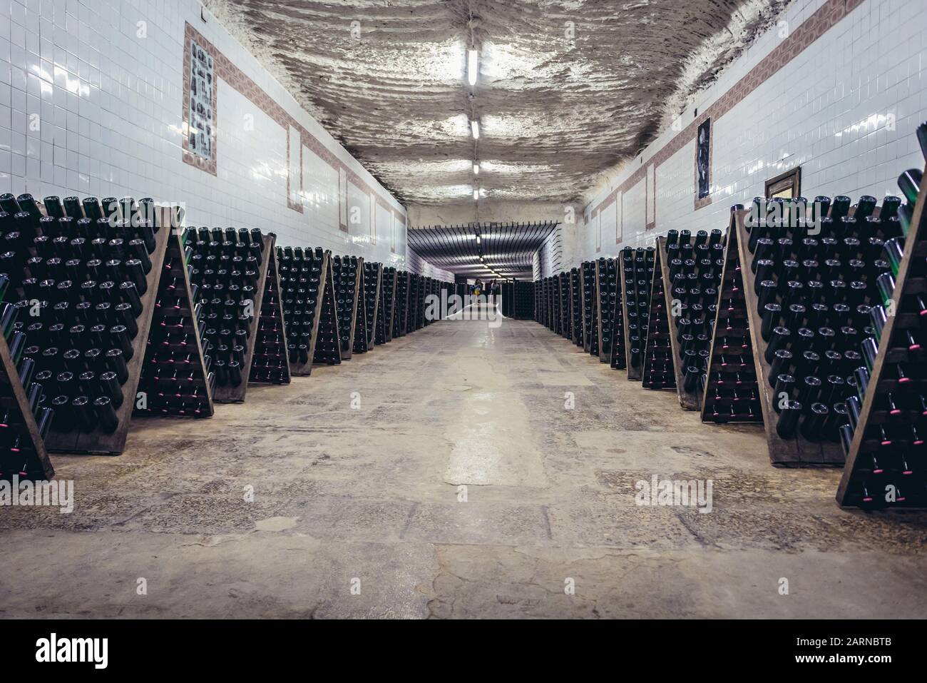 Storage room with wine bottles during production prcess called riddling