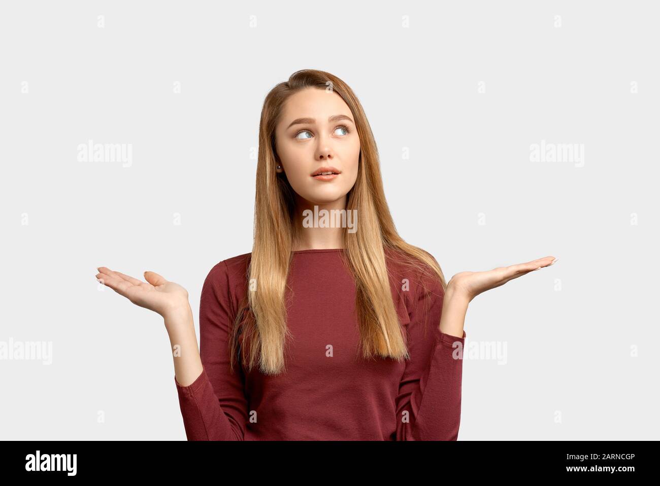 wistful girl spreads hands in different directions Stock Photo Alamy