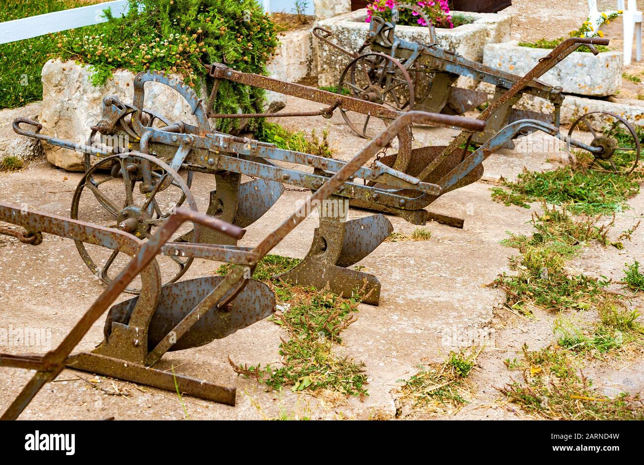 Ancient iron plows on a farm in the countryside of Puglia Stock Photo