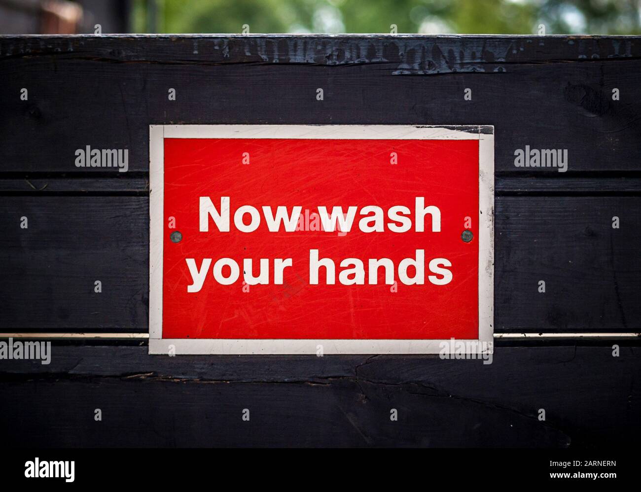 Now wash your hands sign to protect agains infection and contamination at zoo Stock Photo