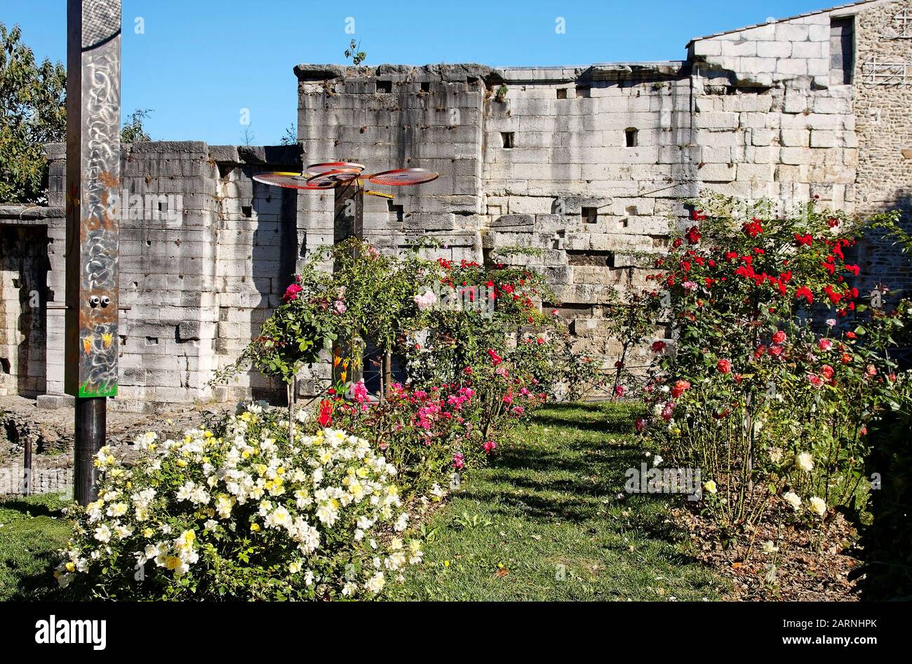 Cybele Archeological Garden, flowers, old Roman ruins, stone, ancient remains, contrasting textures, Vienne, France, summer, horizontal Stock Photo