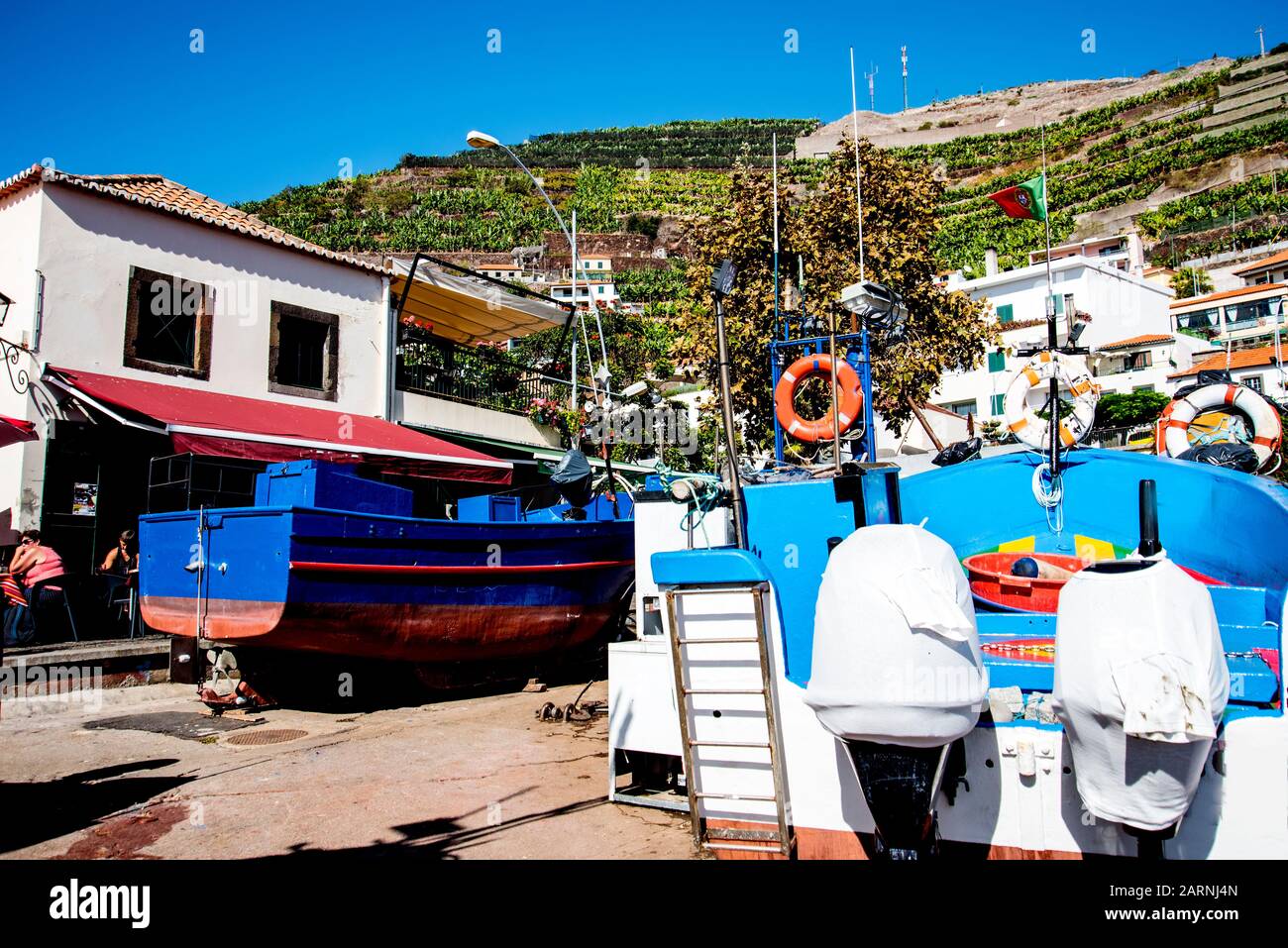 Camara de Lobos is a picturesque fishing village with high cliffs near