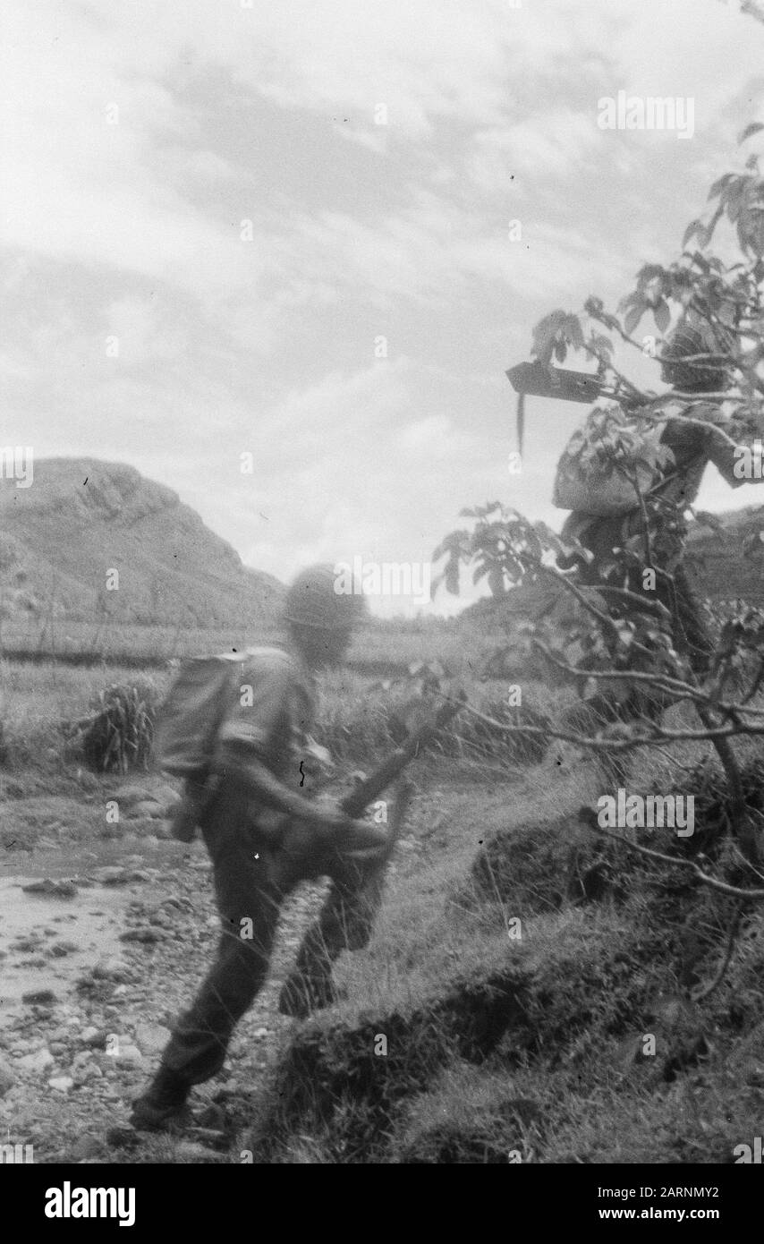 Action of the V-Brigade, Gadja Merah [the Red Elephant] in Bekal and surroundings  [Two soldiers have crossed the rock bed of a kali and reached the shore] Date: 30 March 1949 Location: Bekal, Indonesia, Dutch East Indies Stock Photo